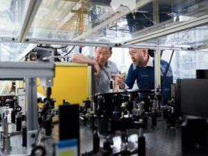 Two men talking in a science lab