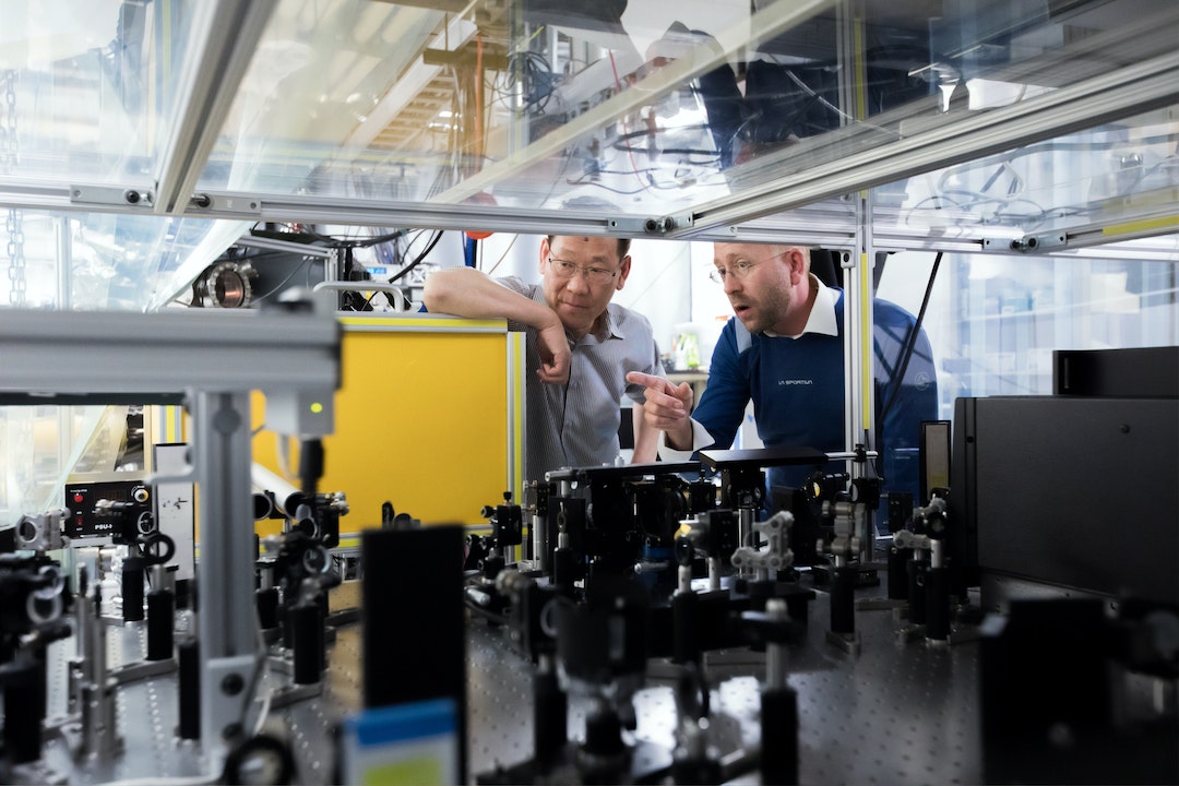 Two men talking in a science lab